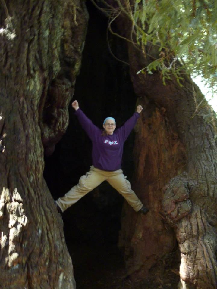 Super hero pose in a Redwood tree
